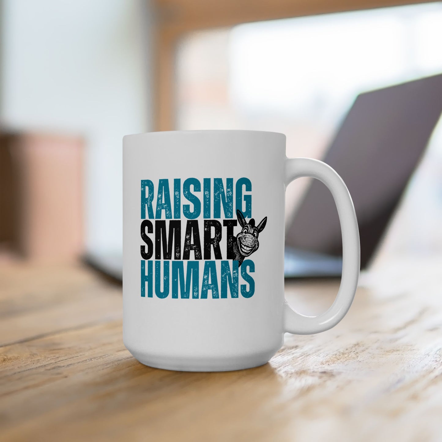 White mug with 'RAISING SMART HUMANS' text on a wooden surface